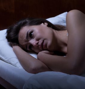 Close up of woman in bed unable to get to sleep