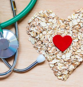 A stethoscope and oats in a heart shape to represent heart health