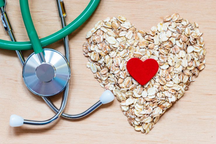 A stethoscope and oats in a heart shape to represent heart health