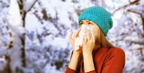 Woman in winter blowing her nose