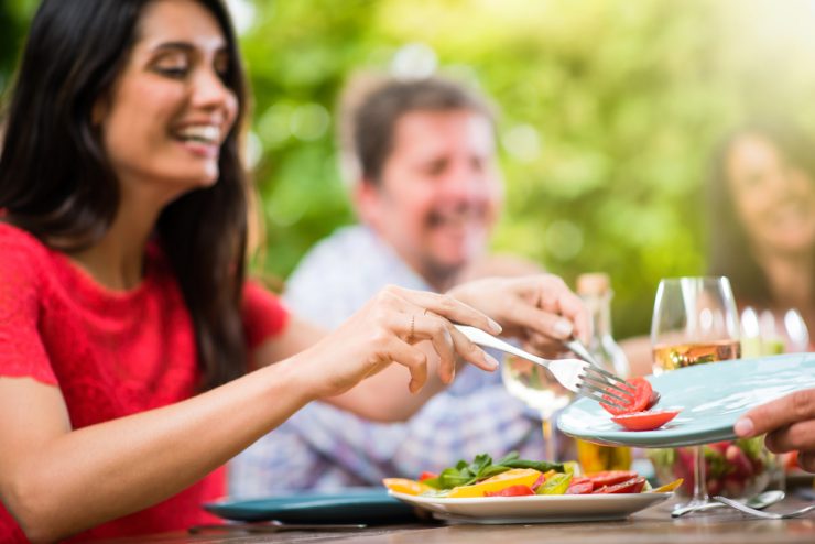 People enjoying eating outdoors representing summer nutrition