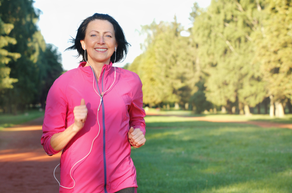 MIddle aged woman jogging in a park