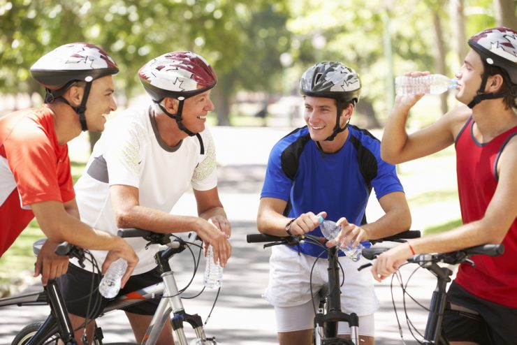 A group of men on bicyles stopping for a chat