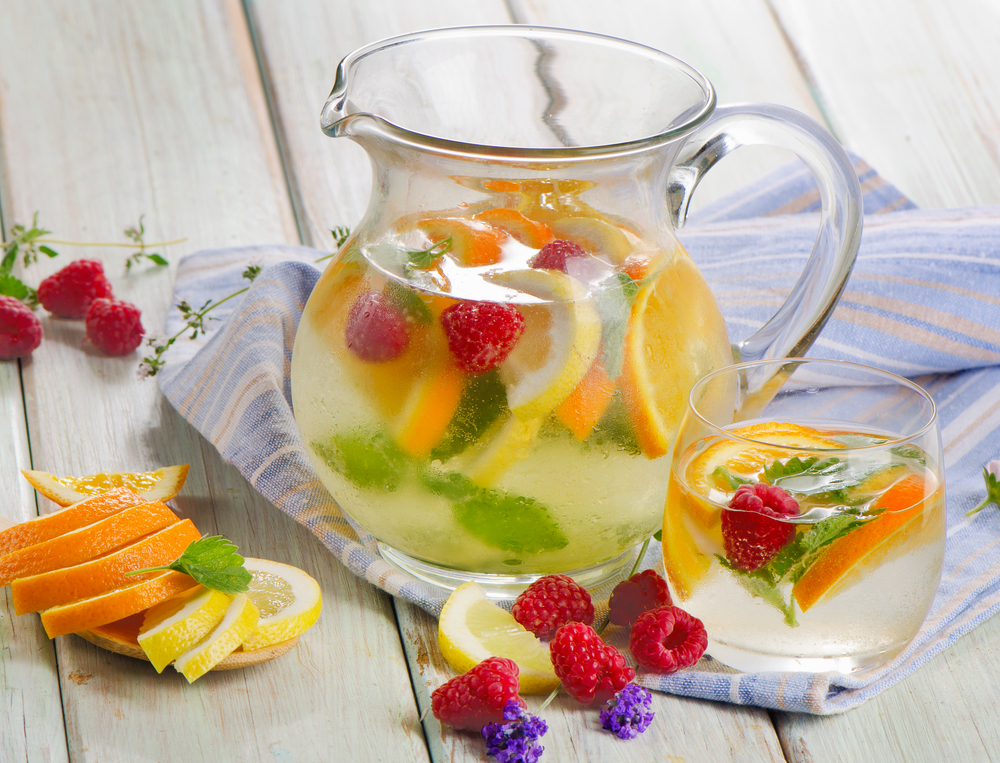A jug of water with fresh fruit in