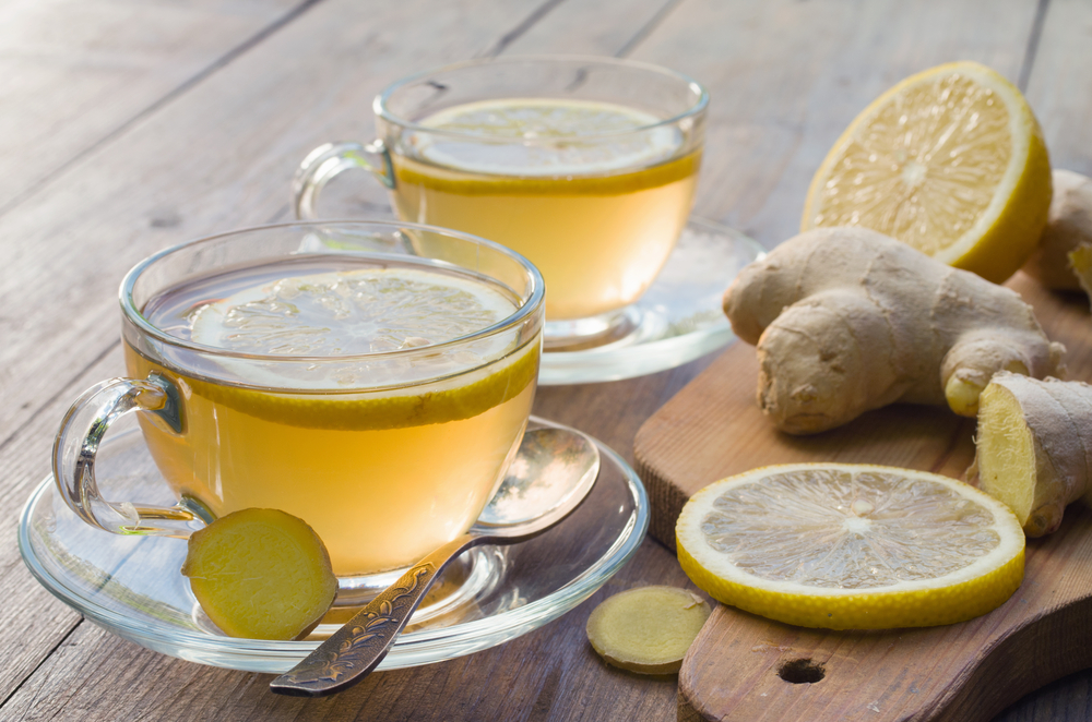 Two cups of ginger tea with ginger root