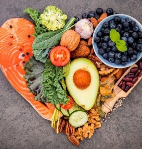 A group of heart healthy foods in a heart shape