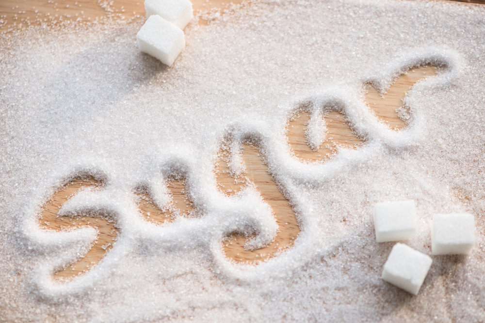 The word sugar written in white sugar