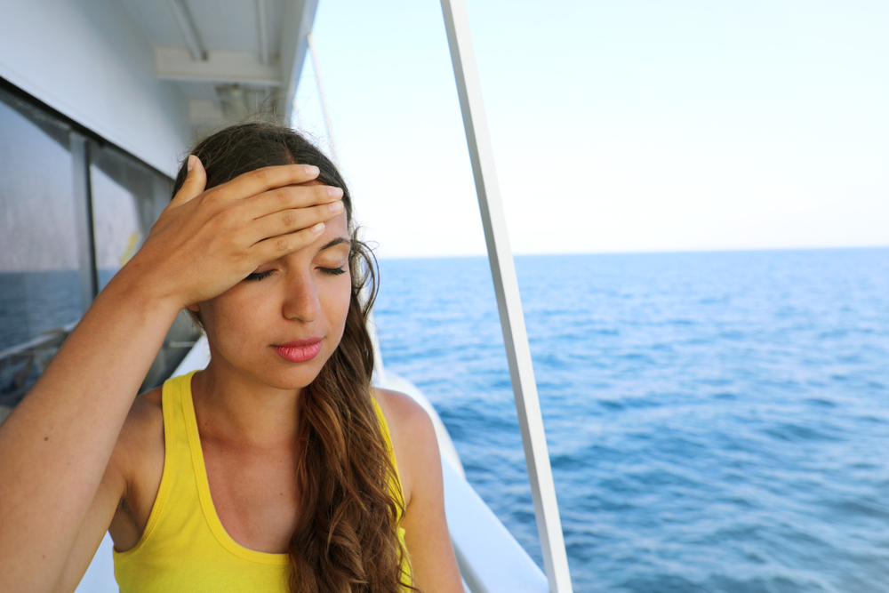 Close up of woman on a boat suffering with travel sickness